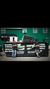 Todd and Rory Flannery leaning against their dumpster for junk and trash removal