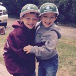 little boys wearing Flannery hats smiling