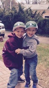little boys wearing Flannery hats smiling