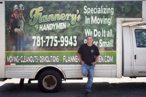 Todd leaning against Flannery's truck for moving services