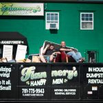 Todd and Rory sitting inside Flannery's dumpster for junk removal services