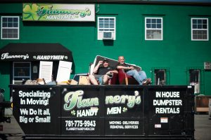 Todd and Rory sitting inside Flannery's dumpster for junk removal services