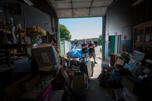 Todd and Rory looking into a hoarder home's garage