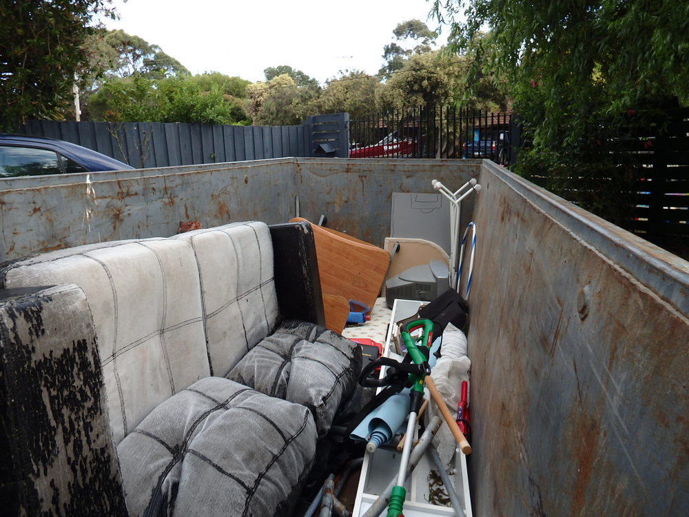 junk removal services with items in a dumpster