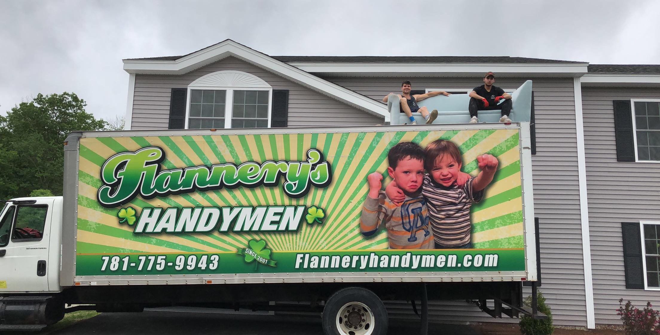 Flannery's Handymen truck with movers sitting on top on a couch