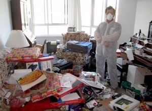 man in his hoarder home with a mask on