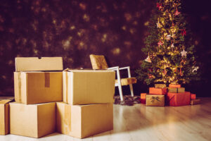 moving boxes in front of a Christmas tree