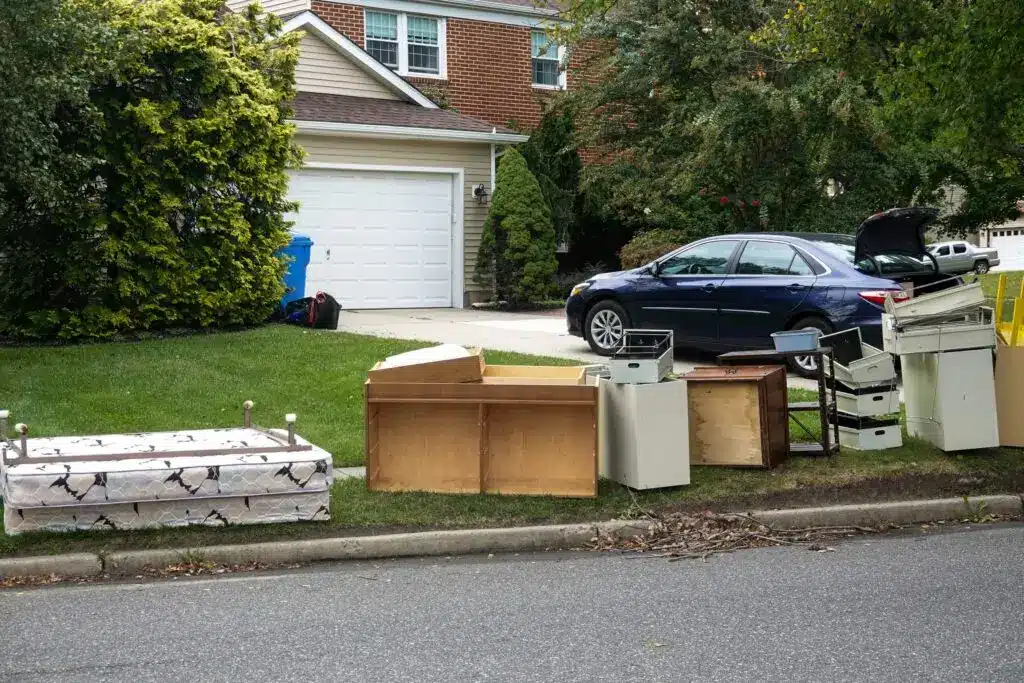 junk removal items ready by the homes curb for pickup